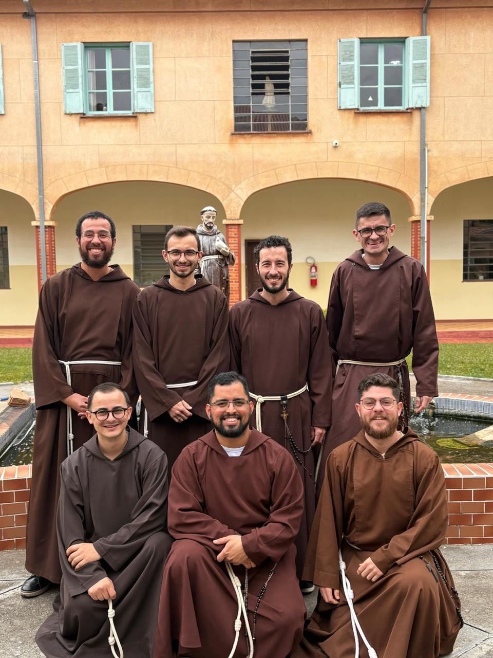 Frades capuchinhos reunidos no pátio da fraternidade